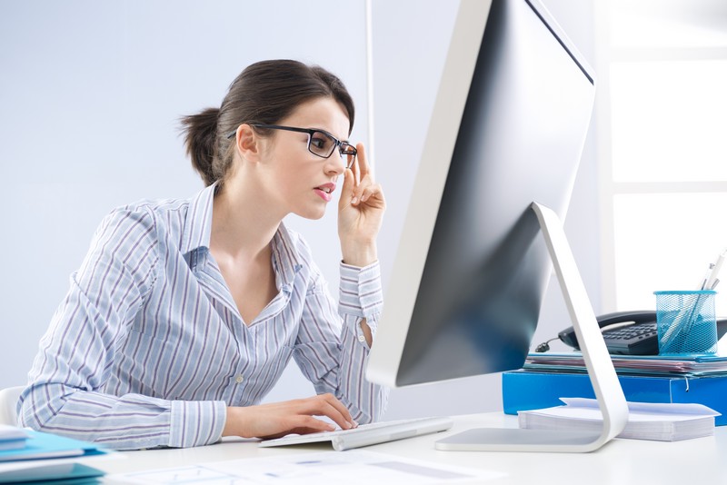 Person experiencing computer vision syndrome symptoms